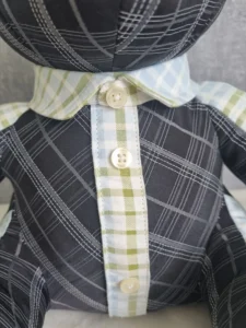 close-up of a patchwork memory bear with a handmade fabric tie