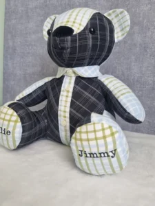 seated patchwork memory bear made from black cream and green fabric