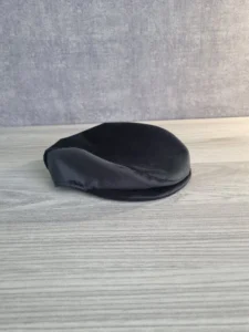 handmade black flat cap accessory displayed for a memory bear