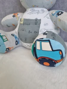 personalised memory bear with a fabric car detail on its paw