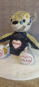 front view of a personalised memory bear made from navy patterned clothing